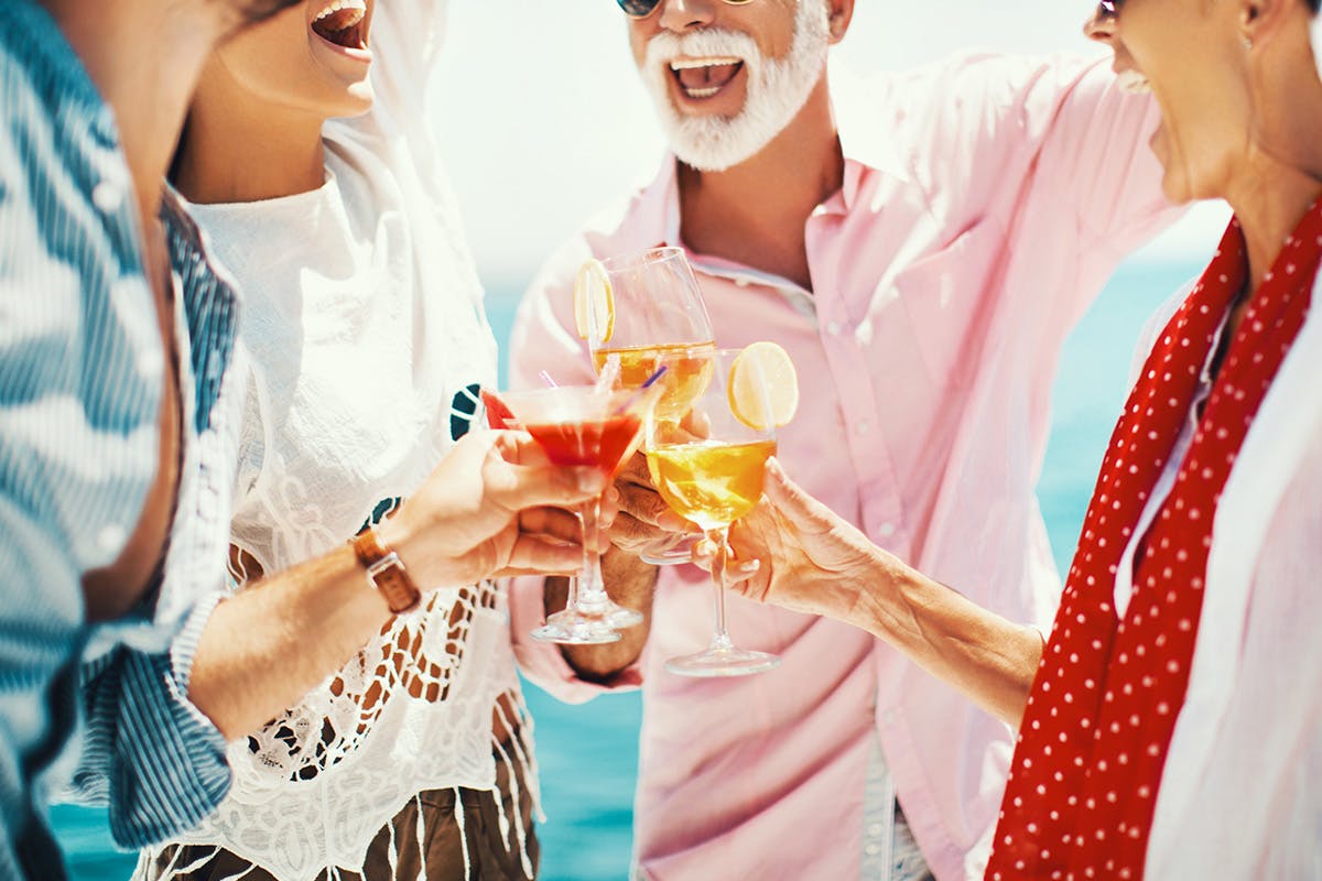 Two men and two ladies toasting and smiling